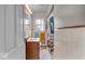 This bathroom features a single sink vanity, tiled walls, and a tub shower with colorful curtain at 5935 Compton St, Indianapolis, IN 46220