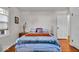 This naturally lit bedroom includes hardwood floors, a window and a doorway to another room at 5935 Compton St, Indianapolis, IN 46220