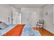 This primary bedroom features hardwood floors and a sitting area with a chair near a window at 5935 Compton St, Indianapolis, IN 46220