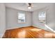 Bedroom featuring hardwood floors, two windows and neutral walls, providing a serene retreat at 5935 Compton St, Indianapolis, IN 46220