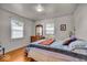 This cozy bedroom features hardwood floors and two windows for ample natural light at 5935 Compton St, Indianapolis, IN 46220