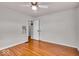 This bedroom has hardwood floors and access to an adjacent room through a white door at 5935 Compton St, Indianapolis, IN 46220