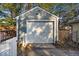 Detached garage with white door and white picket fence at 5935 Compton St, Indianapolis, IN 46220