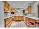 Spacious kitchen featuring wood cabinetry, ample counter space, and tile flooring at 5935 Compton St, Indianapolis, IN 46220
