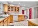 Kitchen with wood cabinets, a breakfast bar, and an adjacent red door leading to another room at 5935 Compton St, Indianapolis, IN 46220