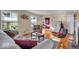 Bright living room featuring hardwood floors, large windows, and a view of the front door, creating an inviting space at 5935 Compton St, Indianapolis, IN 46220