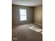 Sun-filled bedroom boasts a large window and neutral carpet at 6030 Tybalt Cir, Indianapolis, IN 46254
