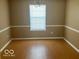 Inviting dining room featuring a window, modern light fixture, and chair rail molding at 6030 Tybalt Cir, Indianapolis, IN 46254