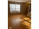 Inviting living room with large window allowing natural light and hardwood floors at 6030 Tybalt Cir, Indianapolis, IN 46254