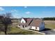 Aerial view of a two-story home with a brown roof, full front porch and two-car garage at 6416 E Urmeyville Rd, Franklin, IN 46131