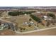 An aerial view of a property featuring a charming home, spacious yard, driveway, and surrounding rural landscape at 6416 E Urmeyville Rd, Franklin, IN 46131