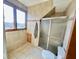 Bright tiled bathroom features a walk-in shower with glass doors and a built-in shower niche at 6416 E Urmeyville Rd, Franklin, IN 46131