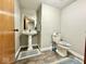 Clean and simple half-bathroom features a pedestal sink, wood-look flooring and toilet at 6416 E Urmeyville Rd, Franklin, IN 46131