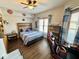This bedroom features a wood-look floor, blue accents, and natural light from the window at 6416 E Urmeyville Rd, Franklin, IN 46131