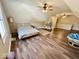 Large upper-level bedroom with wood-look flooring, ceiling fans, and natural light at 6416 E Urmeyville Rd, Franklin, IN 46131