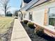 Beautifully landscaped pathway leading to a home with rustic wooden shutters and cozy front porch at 6416 E Urmeyville Rd, Franklin, IN 46131