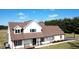 Two-story home showcasing a full front porch, brown roof, and manicured front yard landscaping at 6416 E Urmeyville Rd, Franklin, IN 46131