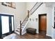 Welcoming foyer with wood staircase, laminate flooring, and natural light at 6416 E Urmeyville Rd, Franklin, IN 46131