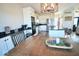 Open-concept kitchen with white cabinetry, granite countertops, and stainless steel appliances flows into the dining area at 6416 E Urmeyville Rd, Franklin, IN 46131