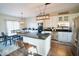 Bright kitchen features stainless steel appliances, center island with seating and wooden dining table set at 6416 E Urmeyville Rd, Franklin, IN 46131