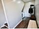 Hallway leading to the laundry room with a washer and dryer, plus convenient coat rack and bench at 6416 E Urmeyville Rd, Franklin, IN 46131
