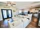 Open concept living area into kitchen with large sectional couch and natural light at 6416 E Urmeyville Rd, Franklin, IN 46131