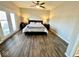 Spacious main bedroom with natural light, laminate flooring, and sliding glass doors at 6416 E Urmeyville Rd, Franklin, IN 46131