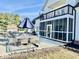 An inviting outdoor patio with comfortable dining set and a screened-in porch with an outdoor balcony at 6416 E Urmeyville Rd, Franklin, IN 46131