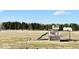 A backyard playground featuring a slide, swings, and playhouse on a grassy yard at 6416 E Urmeyville Rd, Franklin, IN 46131