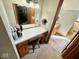 This makeup vanity area has a storage shelf and large mirror with a view into an adjacent bathroom at 6416 E Urmeyville Rd, Franklin, IN 46131