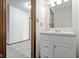 Bathroom with a white vanity and light fixtures, adjacent to the room beyond at 6454 Bay Harbor Ln, Indianapolis, IN 46254