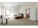Bedroom with ceiling fan, carpet, and a window. Doorway into adjacent room at 6454 Bay Harbor Ln, Indianapolis, IN 46254