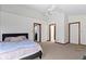 Bedroom featuring carpet, ceiling fan, and doorway to adjacent rooms at 6454 Bay Harbor Ln, Indianapolis, IN 46254