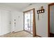 Inviting foyer with white walls, tile flooring, and decorative storm door at 6454 Bay Harbor Ln, Indianapolis, IN 46254