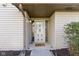 Front door with storm door with decorative windows and 'welcome home' doormat at 6454 Bay Harbor Ln, Indianapolis, IN 46254