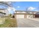 Attached two-car garage with brick facade and concrete driveway and small green lawn to the side at 6454 Bay Harbor Ln, Indianapolis, IN 46254