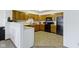 Bright kitchen featuring wood cabinets, black appliances, and laminate countertops at 6454 Bay Harbor Ln, Indianapolis, IN 46254
