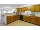Well-lit kitchen featuring wood cabinets, black appliances, and light countertops at 6454 Bay Harbor Ln, Indianapolis, IN 46254