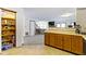 Pantry with well stocked shelves, next to kitchen with wood cabinets and stainless steel appliances for ample storage at 6454 Bay Harbor Ln, Indianapolis, IN 46254