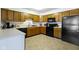 Bright kitchen featuring wood cabinets, black appliances, and laminate countertops at 6454 Bay Harbor Ln, Indianapolis, IN 46254