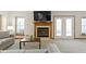 Bright living room boasts fireplace, windows, and comfortable seating, perfect for relaxation and entertaining at 6454 Bay Harbor Ln, Indianapolis, IN 46254