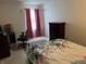 Well-lit bedroom featuring a floral bedspread, dark wood furnishings, and a cozy workspace at , Indianapolis, IN 46217