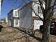 White two-story house featuring a brick-accented garage and mature trees in a sunny, residential neighborhood at , Indianapolis, IN 46217