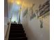 Carpeted stairway with handrail leading up, featuring wall art depicting garden scenes and peaceful nature at , Indianapolis, IN 46217