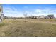 Expansive backyard view showcasing the lawn extending beyond the property, complemented by neighborhood scenery at 6713 Cardiff Dr, McCordsville, IN 46055