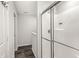 A modern bathroom featuring a shower with glass doors, wood floors, and neutral colors at 6713 Cardiff Dr, McCordsville, IN 46055