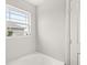 Bright bathroom with a tub and a view from the window; a great place to relax at 6713 Cardiff Dr, McCordsville, IN 46055