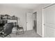 Neutral bedroom with a desk and chair featuring a view into the next room at 6713 Cardiff Dr, McCordsville, IN 46055