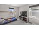 Bedroom with bunk-style bed, media center, and sunny windows offering exterior views at 6713 Cardiff Dr, McCordsville, IN 46055