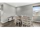 Bright dining room featuring hardwood floors, a modern light fixture, and a large window for natural light at 6713 Cardiff Dr, McCordsville, IN 46055